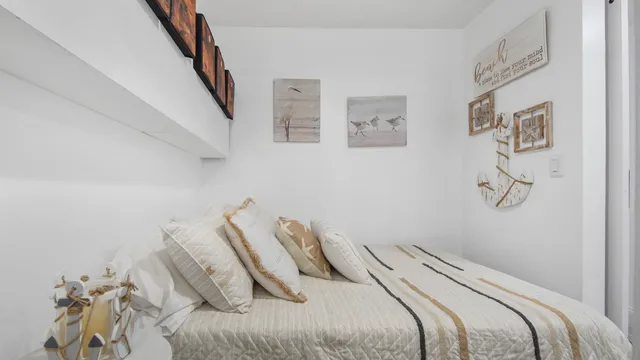 a bedroom with a bed and a painting on the wall