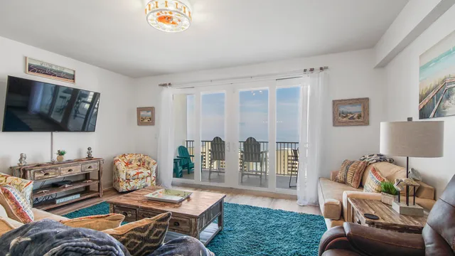 a living room with furniture a flat screen tv and a window