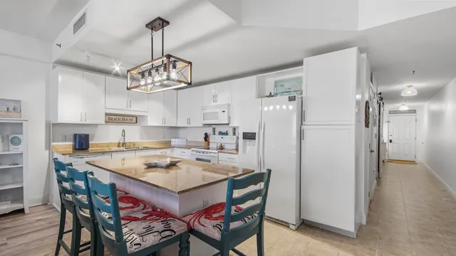 a kitchen with stainless steel appliances a stove a refrigerator and a dining table