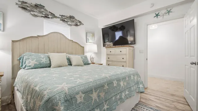 a bedroom with a bed and flat screen tv