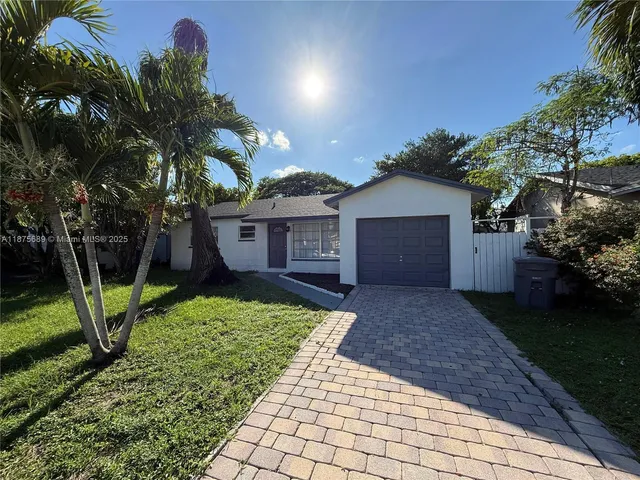 a view of a house with a yard and plants