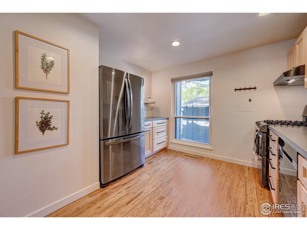 1265 Bear Mountain Drive, Unit B Boulder, CO 80305 - Photo 16 of 24 a kitchen with stainless steel appliances granite countertop a refrigerator and a stove top oven