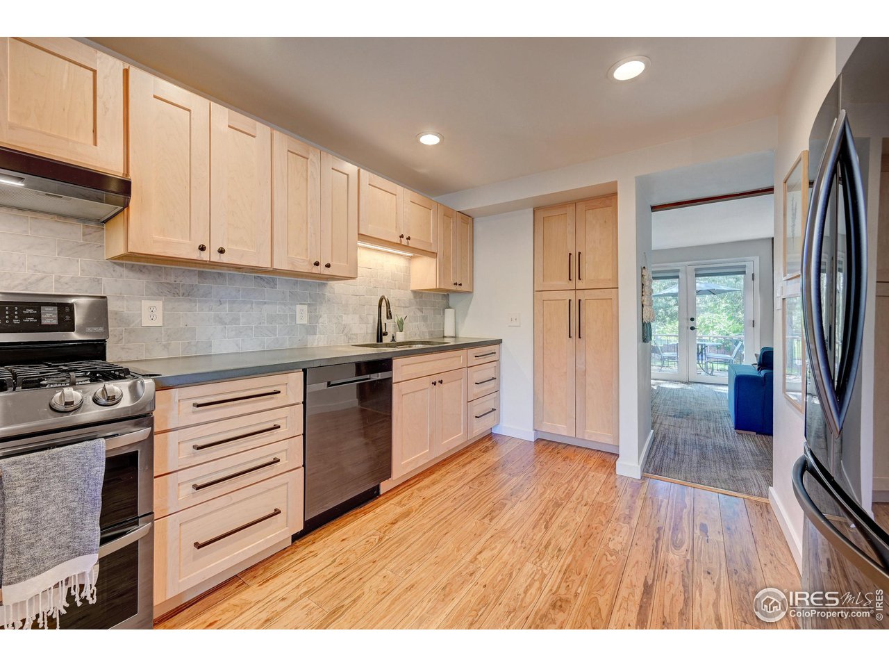 1265 Bear Mountain Drive, Unit B Boulder, CO 80305 - Photo 2 of 24 a kitchen with granite countertop white cabinets and white appliances
