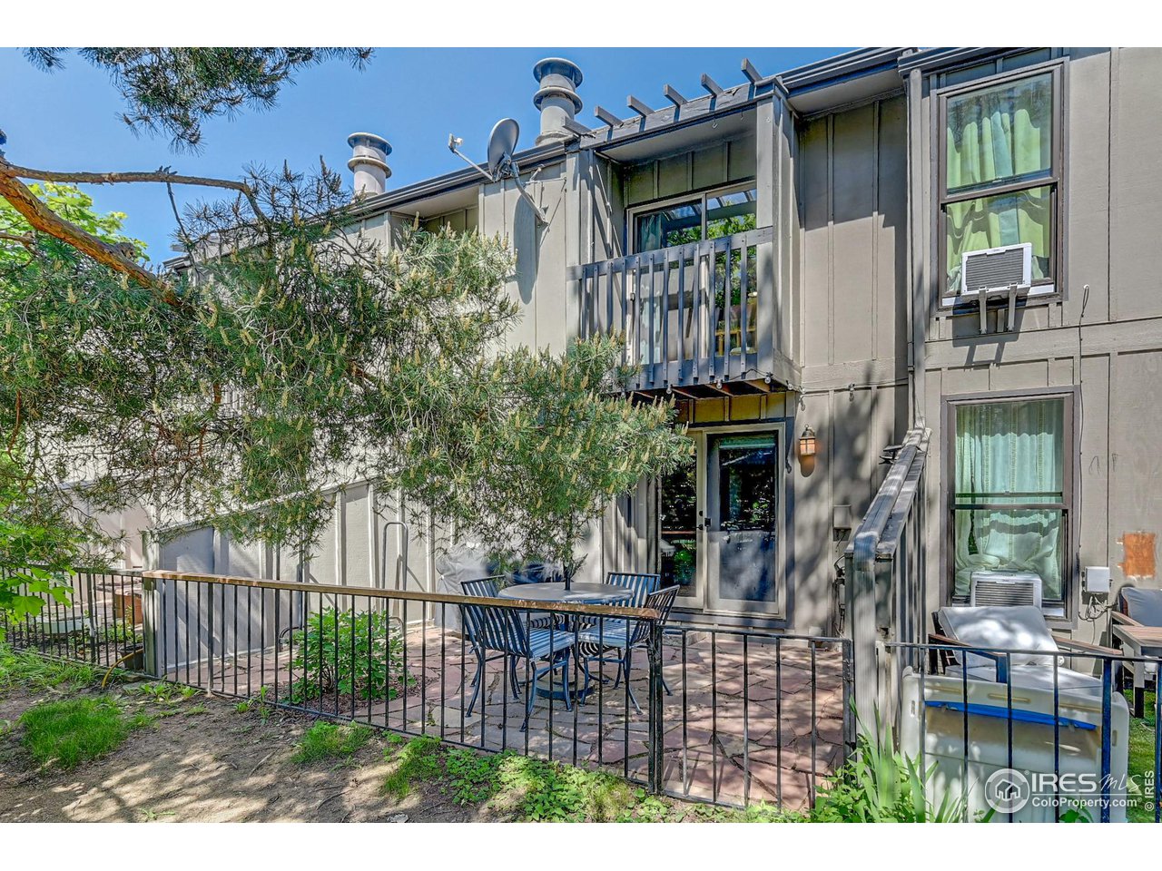 1265 Bear Mountain Drive, Unit B Boulder, CO 80305 - Photo 20 of 24 a view of a house with a porch and furniture
