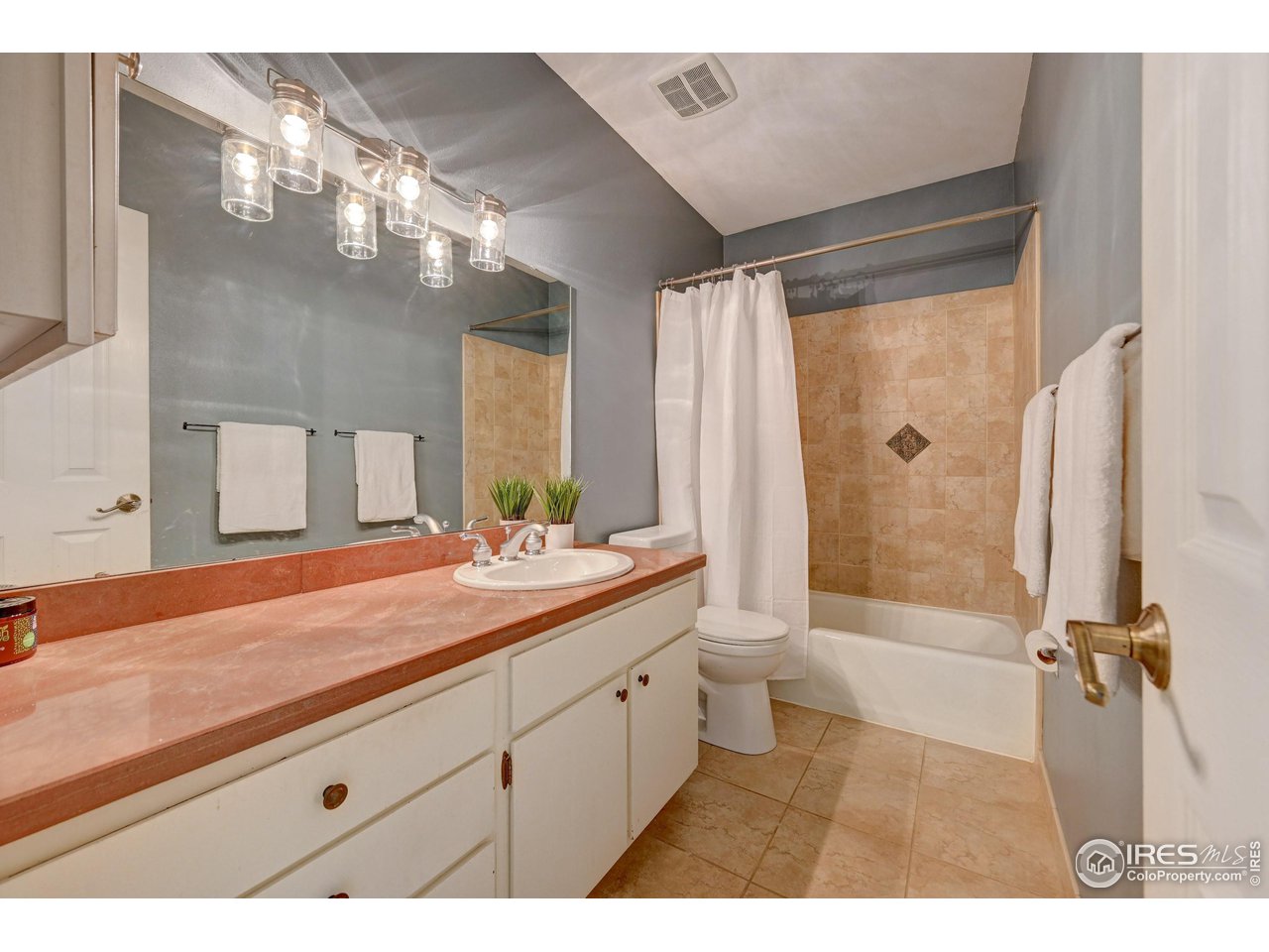 1265 Bear Mountain Drive, Unit B Boulder, CO 80305 - Photo 7 of 24 a bathroom with a granite countertop sink mirror and a shower