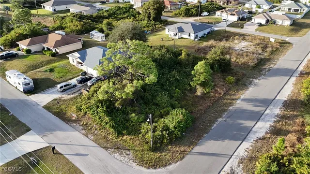 an aerial view of a residential houses with outdoor space