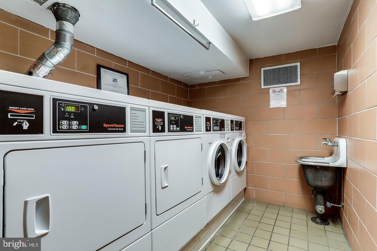 700 7th Street Southwest, Unit 526 Washington, DC 20024 - Photo 29 of 53 Modern laundry room with sleek machines.