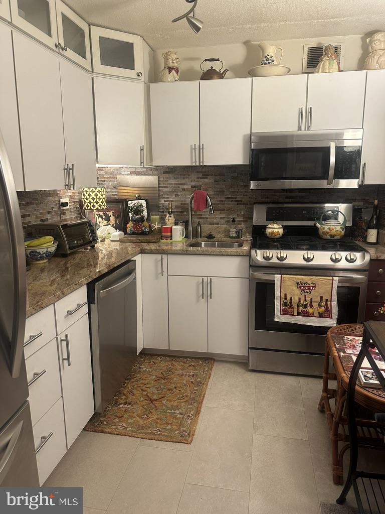 700 7th Street Southwest, Unit 526 Washington, DC 20024 - Photo 9 of 53 Modern kitchen with sleek finishes.