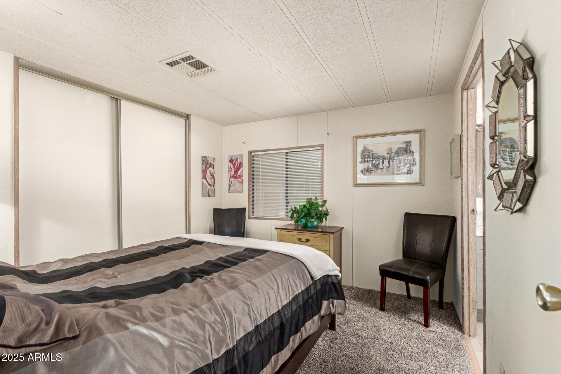 301 South Signal Butte Road, Unit 706 Apache Junction, AZ 85120 - Photo 27 of 51 a bedroom with a bed and a painting on the wall