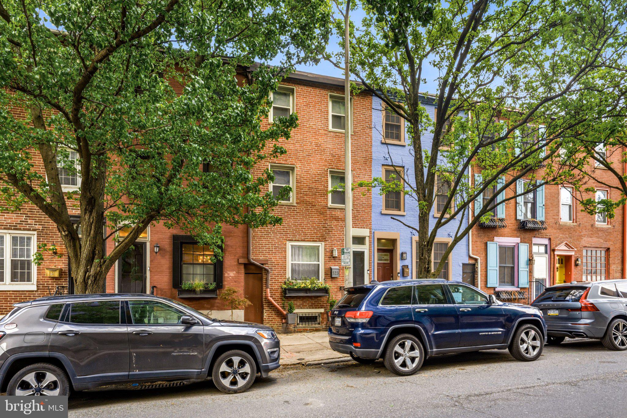 Charming row homes lined with trees.