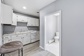 875 North Main Street, Unit 1 Randolph, MA 02368 - Photo 2 of 15 a spacious bathroom with a granite countertop sink and a toilet