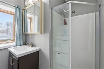 875 North Main Street, Unit 1 Randolph, MA 02368 - Photo 7 of 15 a bathroom with a shower sink and mirror