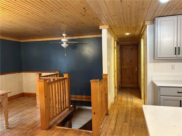 a view of a hallway with wooden floor