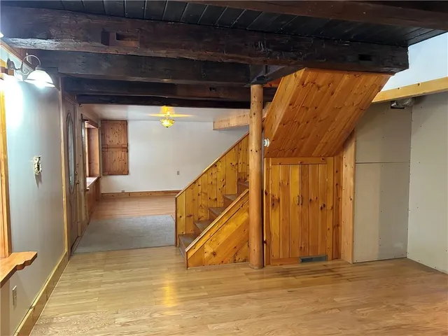 a view of a room with wooden floor