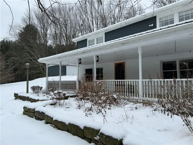 a view of house with outdoor space and sitting area