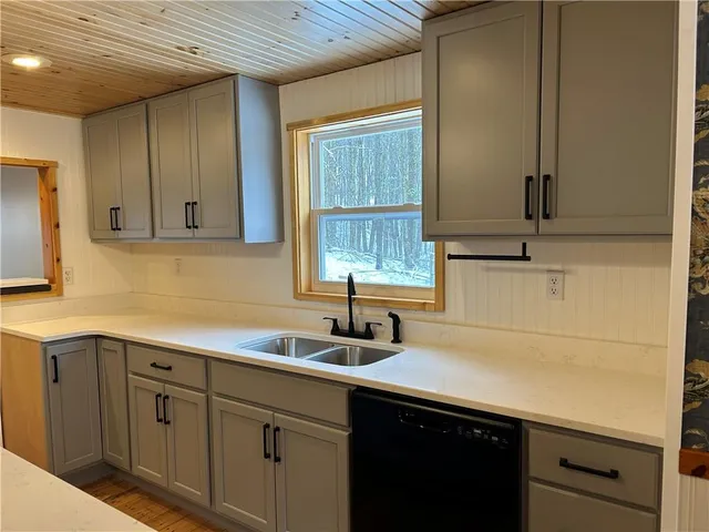 a kitchen with sink and cabinets