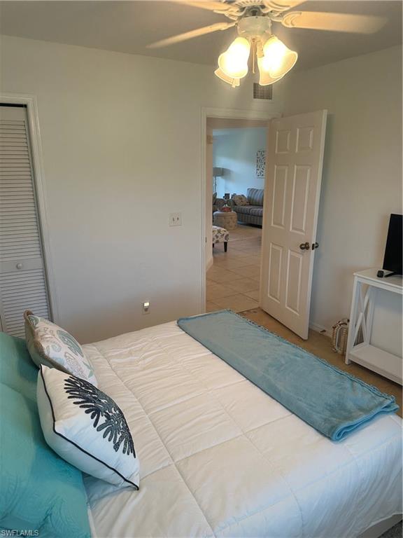 1950 West Crown Pointe Boulevard, Unit B106 Naples, FL 34112 - Photo 10 of 33 a bedroom with a bed and a television in it