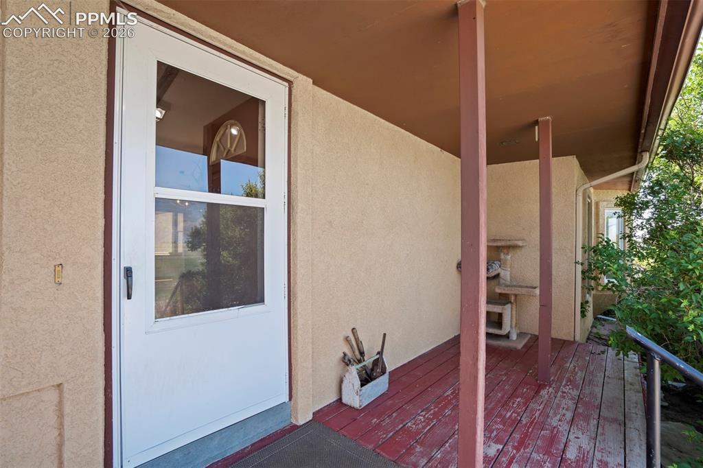 2550 Slocum Road Peyton, CO 80831 - Photo 13 of 50 a view of a hallway with wooden floor and staircase