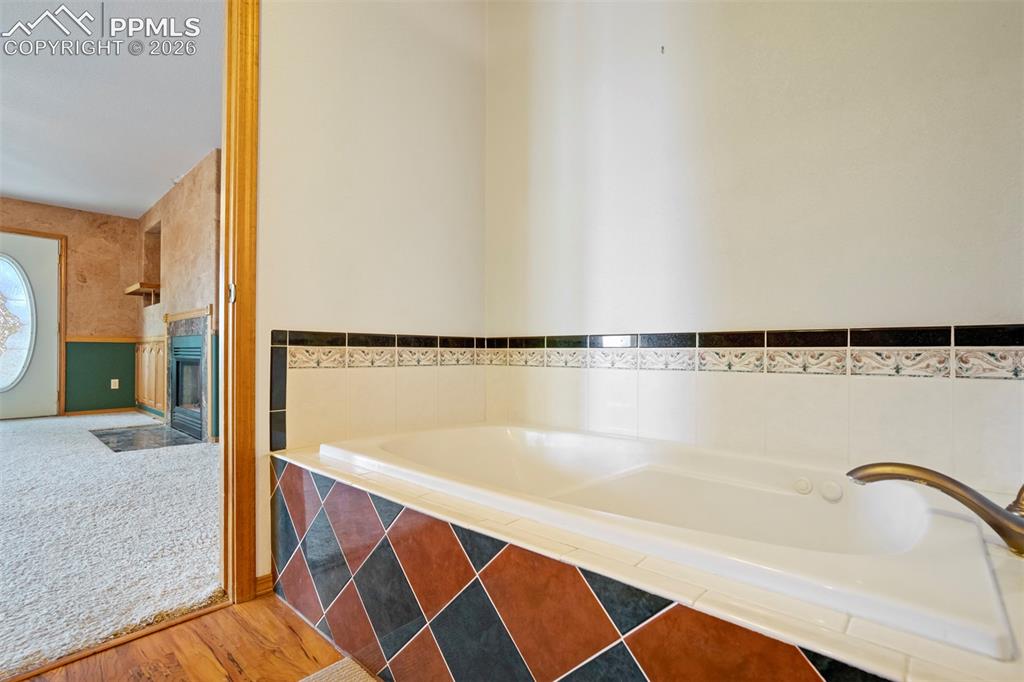 2550 Slocum Road Peyton, CO 80831 - Photo 37 of 50 a bathroom with a bathtub and a shower
