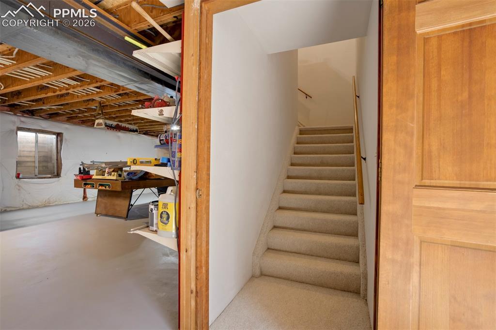 2550 Slocum Road Peyton, CO 80831 - Photo 44 of 50 a view of a livingroom with stairs and a couch
