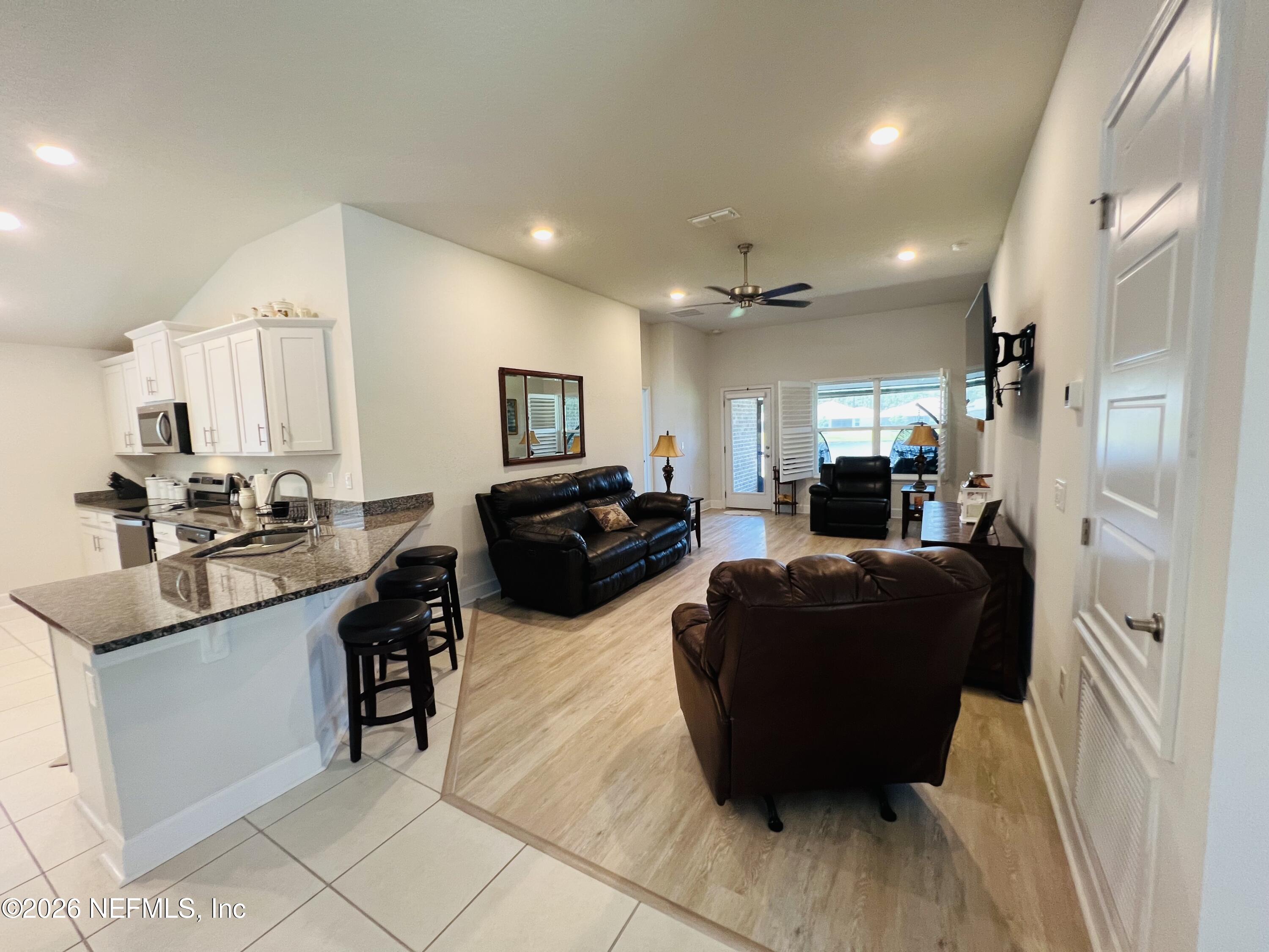 2 Rivertown Road Palm Coast, FL 32137 - Photo 48 of 80 a living room with furniture window and a view of kitchen
