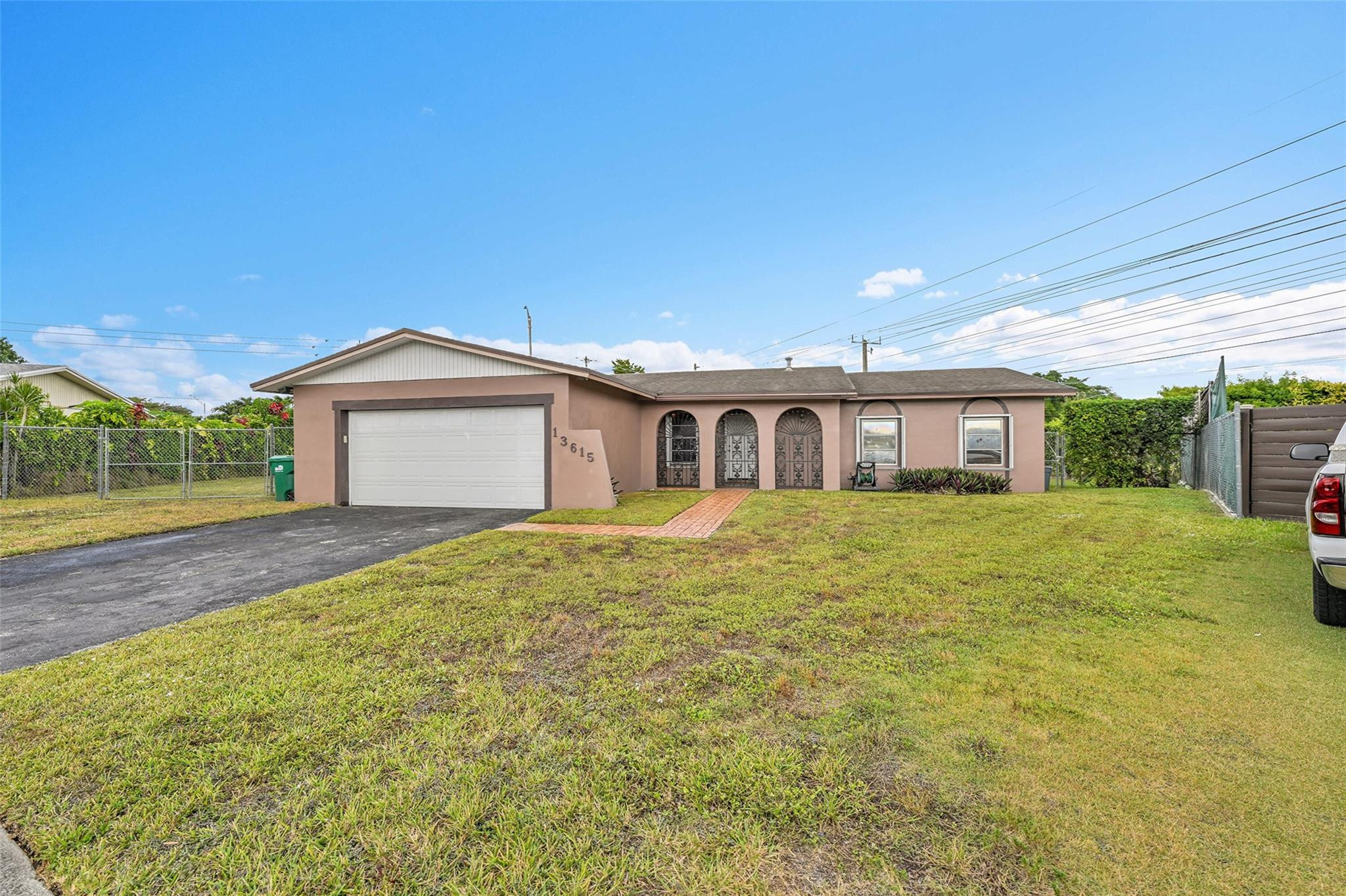 a front view of a house with a garden