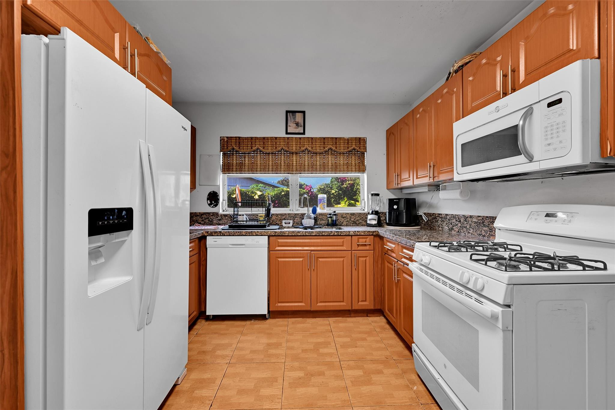 13615 Southwest 72nd Terrace Miami, FL 33183 - Photo 12 of 27 a kitchen with stainless steel appliances granite countertop a stove a sink and a refrigerator