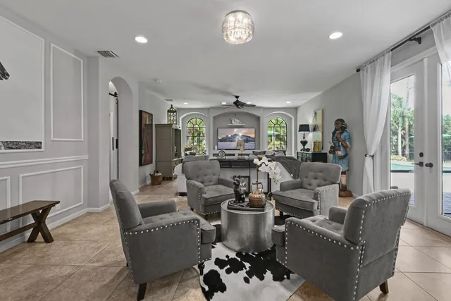 a living room with furniture a dining table and chairs