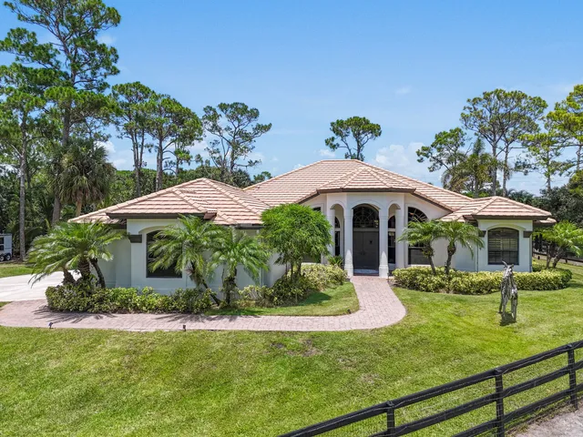 a front view of a house with a yard porch and sitting area