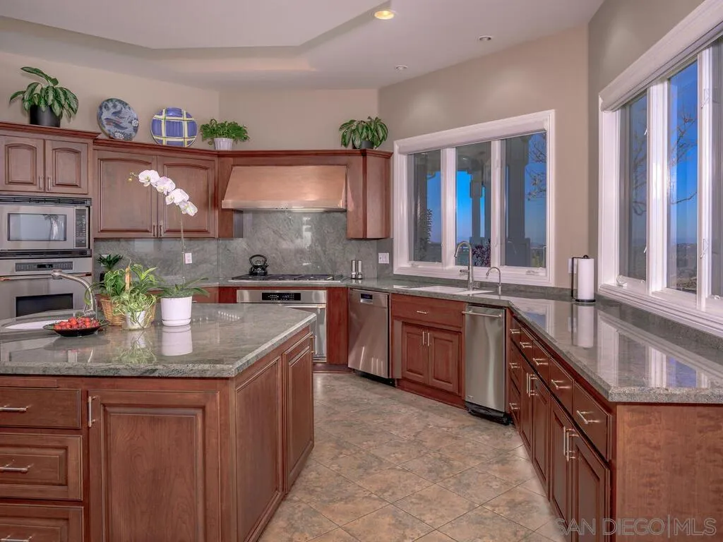 14490 Ridge Ranch Road Escondido, CA 92027 - Photo 11 of 74 a kitchen with stainless steel appliances granite countertop a sink stove and cabinets