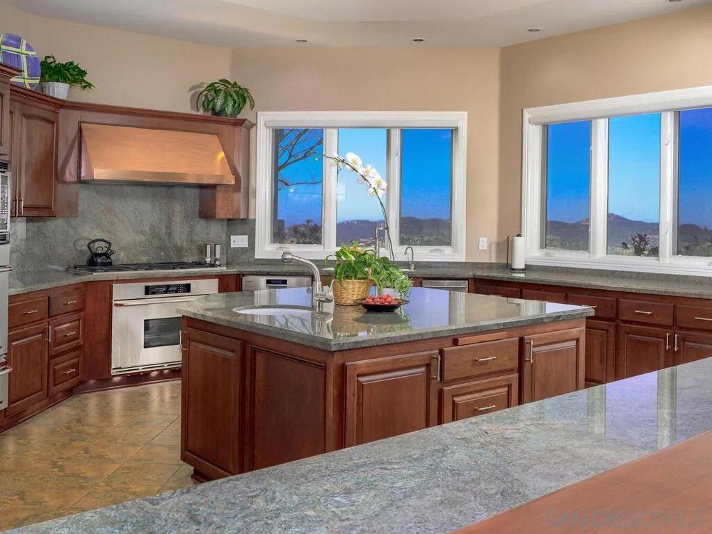14490 Ridge Ranch Road Escondido, CA 92027 - Photo 12 of 74 a kitchen with stainless steel appliances granite countertop a sink stove and cabinets