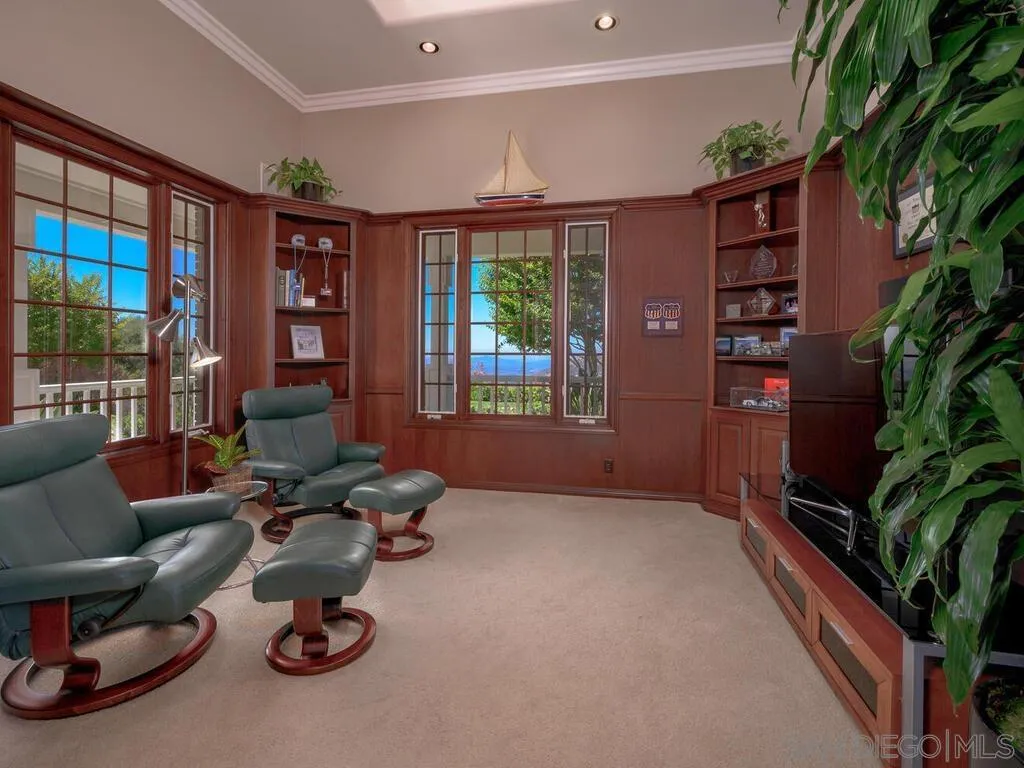 14490 Ridge Ranch Road Escondido, CA 92027 - Photo 17 of 74 a living room with furniture a bookshelf and a large window