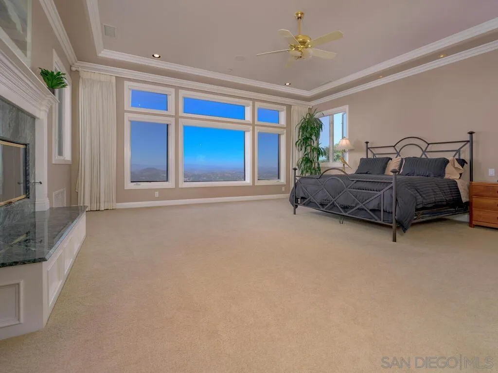14490 Ridge Ranch Road Escondido, CA 92027 - Photo 19 of 74 a spacious bedroom with a bed and a chandelier