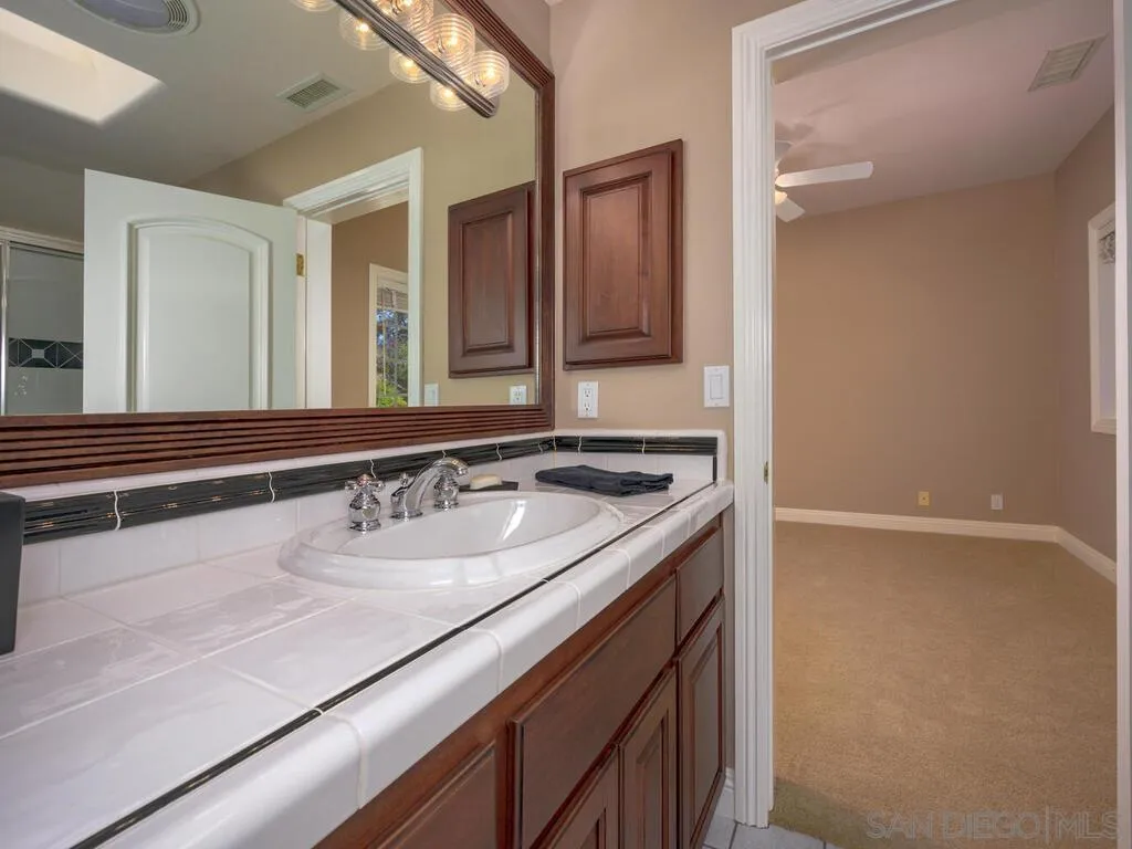 14490 Ridge Ranch Road Escondido, CA 92027 - Photo 25 of 74 a bathroom with a sink and a mirror