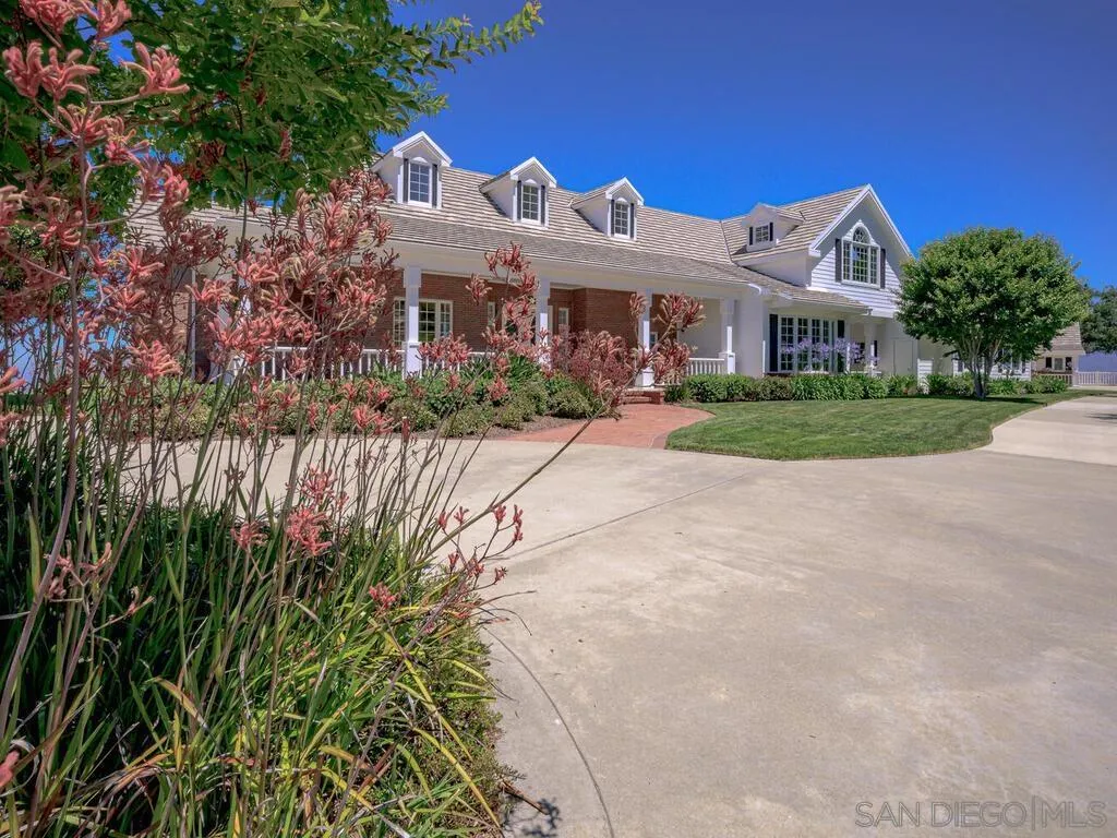 14490 Ridge Ranch Road Escondido, CA 92027 - Photo 3 of 74 a view of a white house with a yard and potted plants