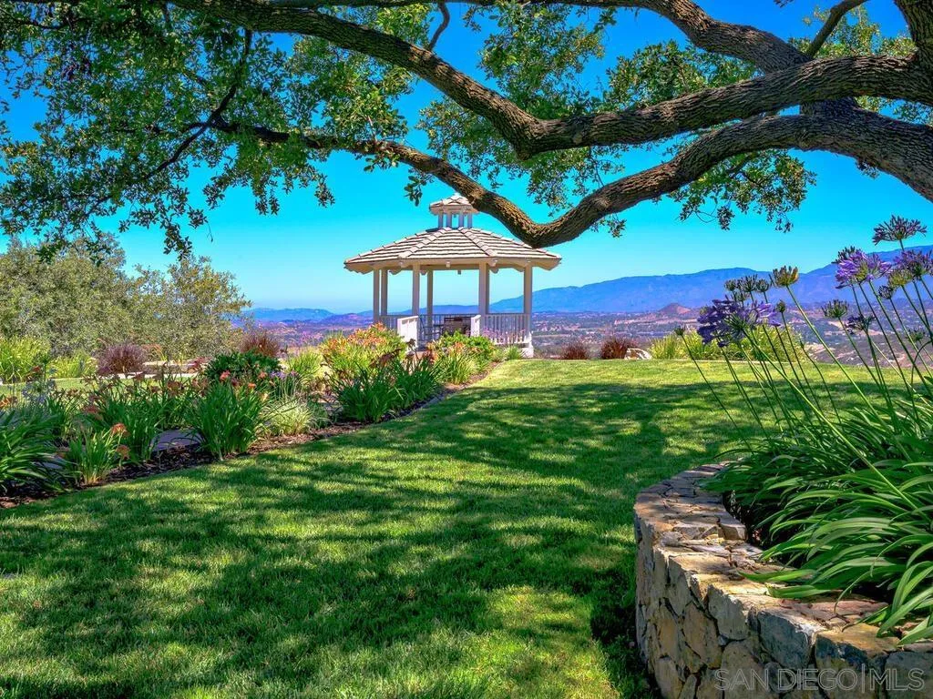 14490 Ridge Ranch Road Escondido, CA 92027 - Photo 31 of 74 a view of a table and chairs under an umbrella