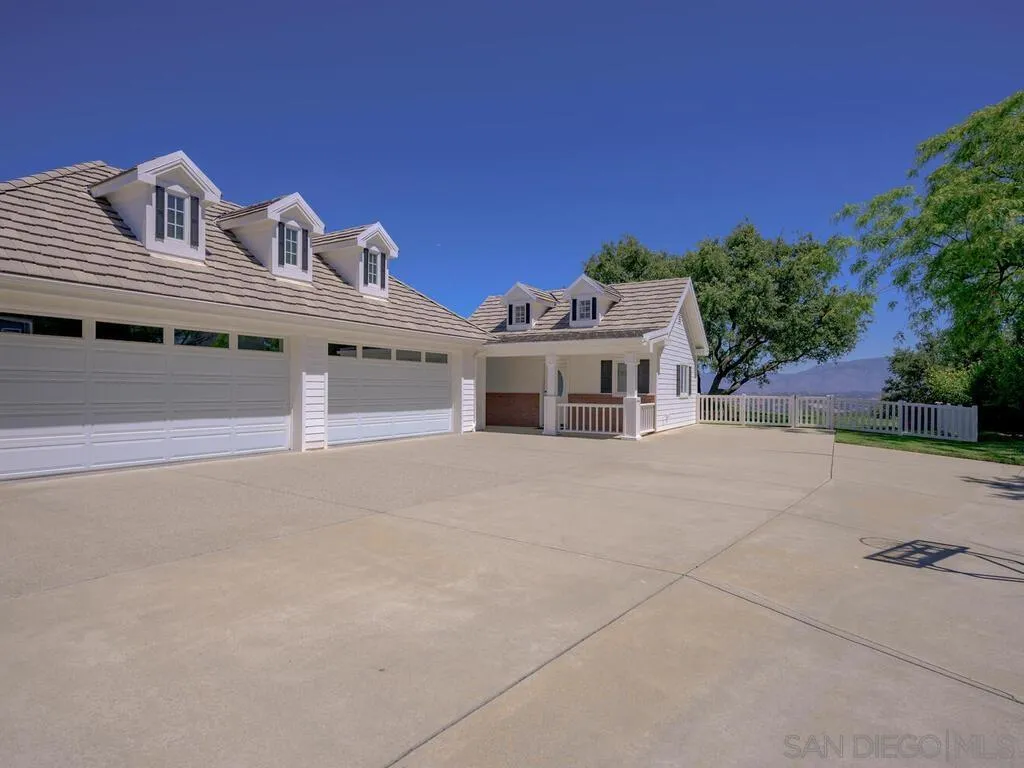 14490 Ridge Ranch Road Escondido, CA 92027 - Photo 65 of 74 a large white building with a large parking space and a car parked in front of it