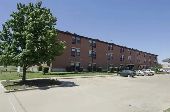 a tall building with trees in the background