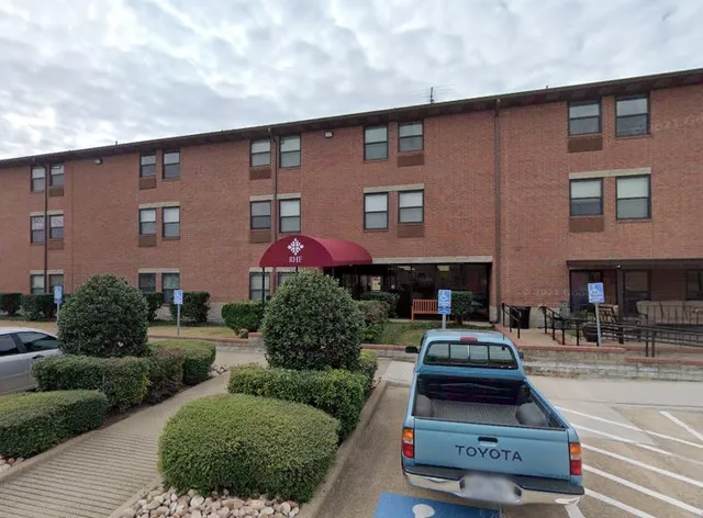 a car parked in front of a brick building