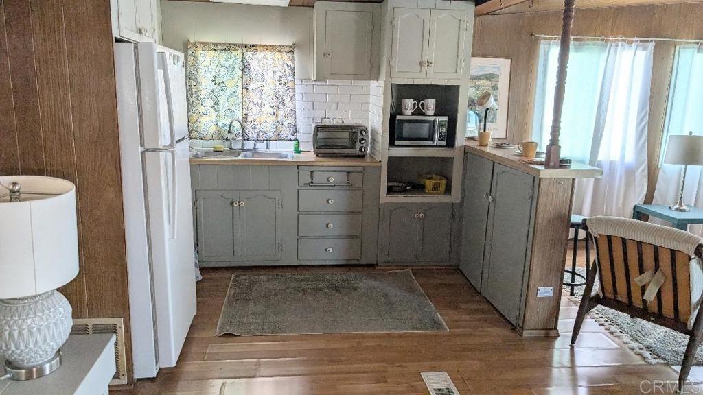 9459 Mission Gorge Road, Unit 68 Santee, CA 92071 - Photo 3 of 13 a kitchen with stainless steel appliances granite countertop a refrigerator and a stove