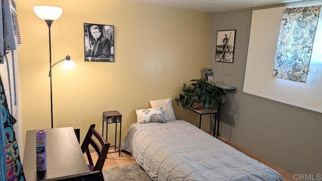 9459 Mission Gorge Road, Unit 68 Santee, CA 92071 - Photo 6 of 13 a bedroom with a bed and a table in it