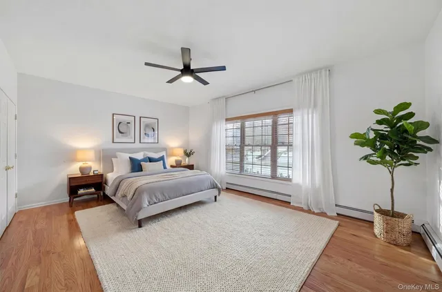 a bedroom with a bed lamp and a potted plant