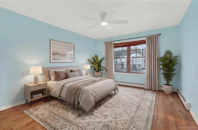 a living room with a bed furniture and a potted plant