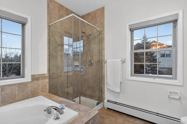 a bath tub sitting in a bathroom next to a window