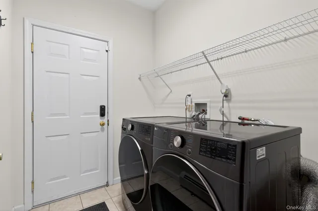 a view of a hallway with wooden floor and a living room