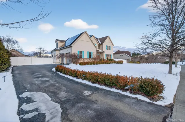 a view of a house with a yard and sitting area