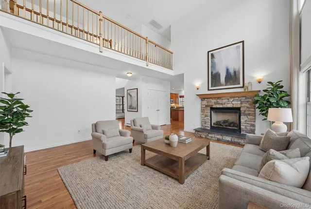 a living room with furniture a fireplace and potted plant