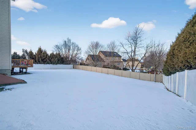 a view of a roof deck with table and chairs with wooden floor and fence