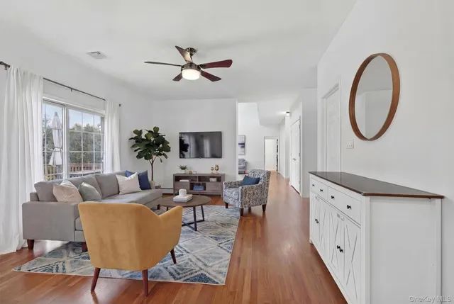 a living room with furniture a fireplace and a large window