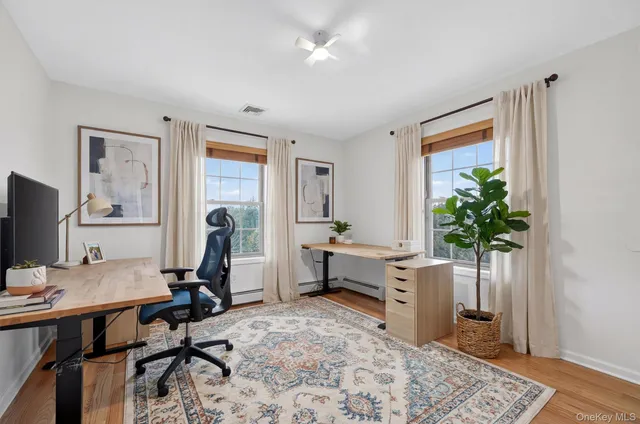 a view of a workspace with furniture and a potted plant